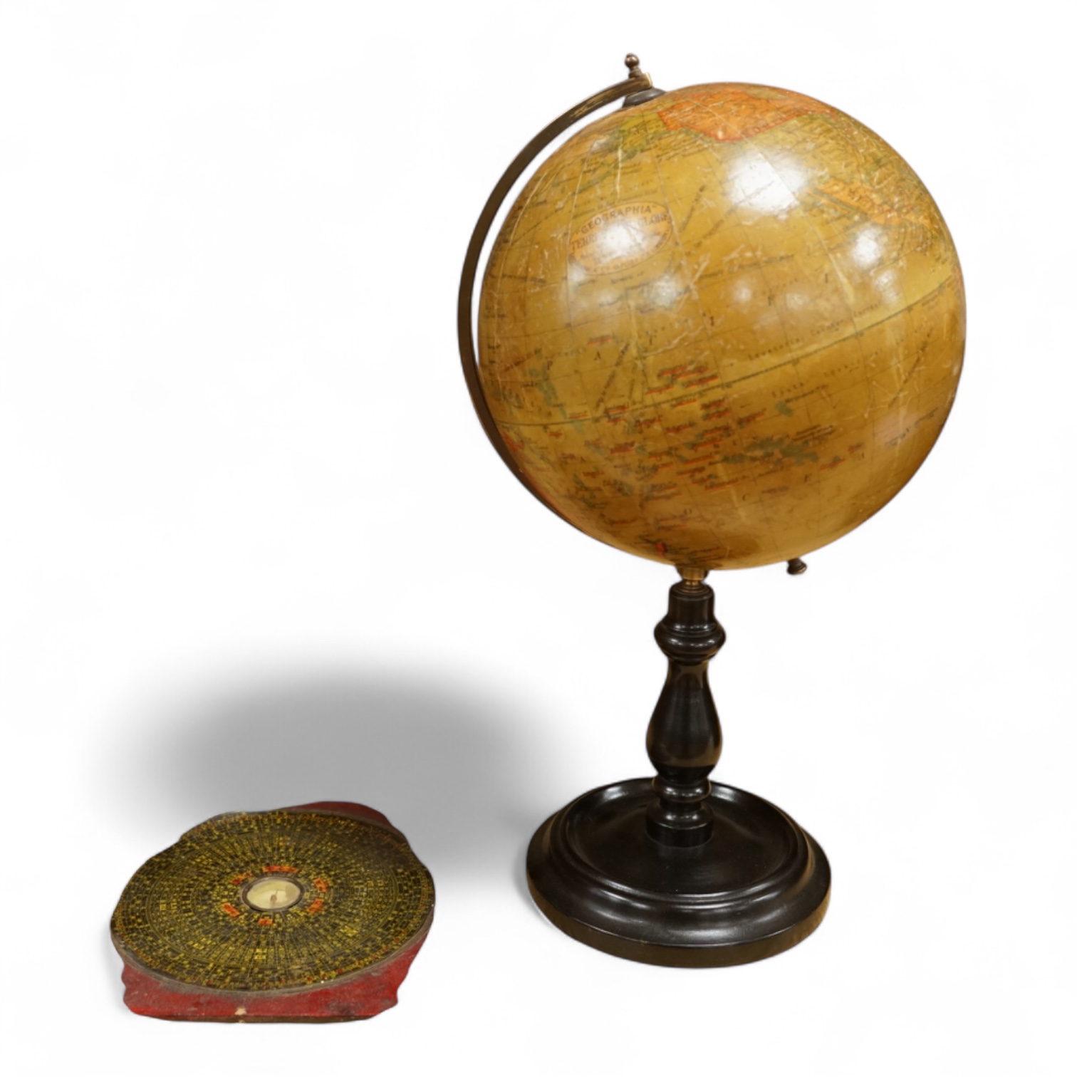 A Geographica 8 inch globe on a turned ebonised wood stand, 39cm high, together with a Chinese ‘Luopan’ compass, for use in feng shui practice.